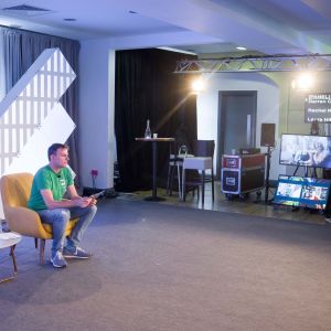 Johnny-C-seated-wide-angle-studio